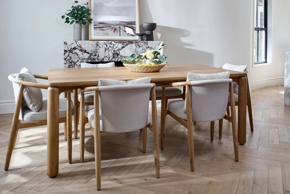 Dining room with Dillong Dining Table and Dillon Dining Chairs on a wooden floor.