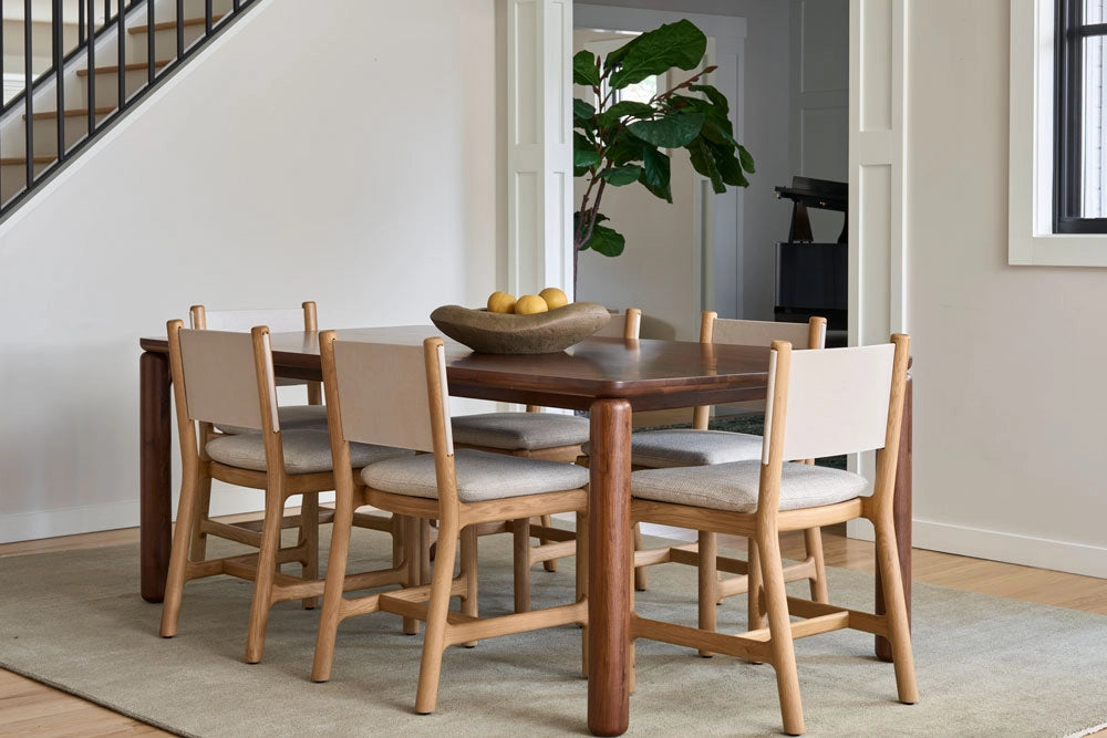 Dining room with the DIllon Dining Table and chairs on a light-colored rug.