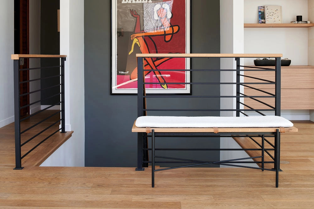 Modern interior with a the Highline Bench, wooden floor, and abstract art on the wall.