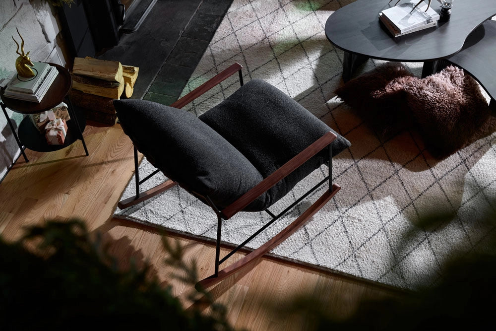 Modern Indoor Vail Rocker on a patterned rug in a room with sunlight filtering through.