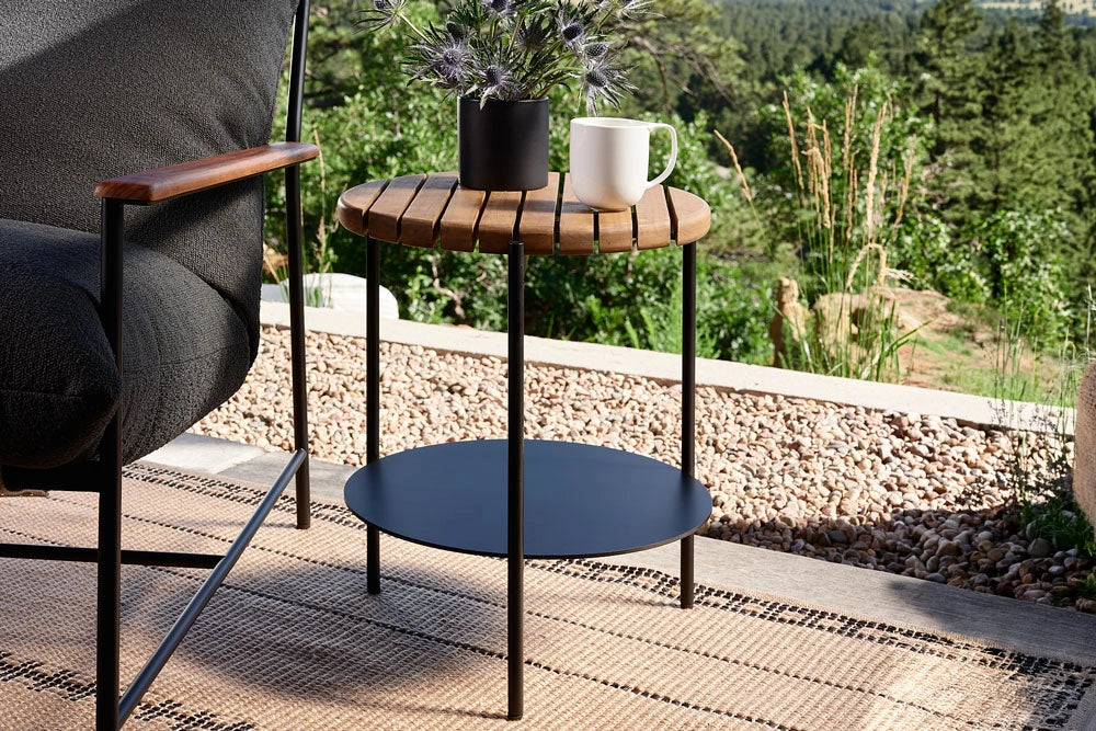 Outdoor Strata Side Table on a patio with plants in the background